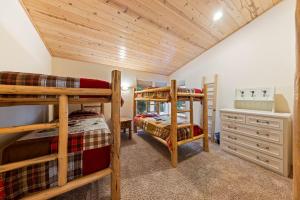 a bedroom with two bunk beds in a house at Fox Crossing at Tahoe Donner Vacation Rental w Forested Views in a Prime Location in Truckee