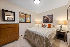 a bedroom with a bed and a dresser and a mirror at Nightingale Retreat - 3BR, Close to Tahoe City, Walk to Bike Path, Private Beach Access in Tahoe City