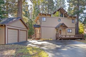 a house with a garage and a driveway at Nightingale Retreat - 3BR, Close to Tahoe City, Walk to Bike Path, Private Beach Access in Tahoe City