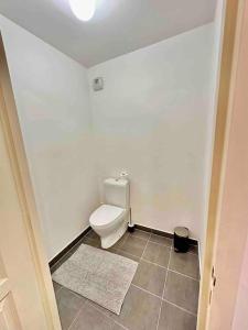 a bathroom with a toilet and a tile floor at Magnificent apartment Paris Bagnolet 201 in Bagnolet