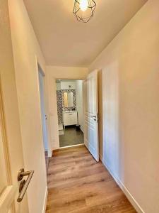 an empty room with a hallway with a door and a mirror at Magnificent apartment Paris Bagnolet 201 in Bagnolet