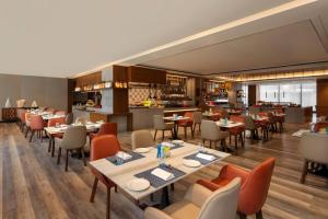 a restaurant with tables and chairs and a bar at Courtyard by Marriott Amritsar in Amritsar