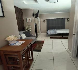 a living room with a couch and a table at Green Castle Apartment in Tampa Near Airport and Busch Gardens in Tampa