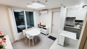 a small kitchen with a white table and chairs at Full option two-room, Exclusive use, mountain view, public transportation 5 minutes away in Seoul