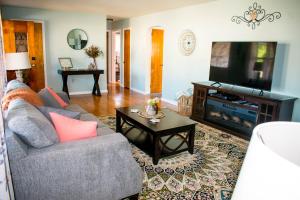 a living room with a couch and a flat screen tv at Private space, while visiting family this Holiday! in Pottstown
