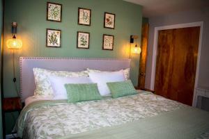 a bedroom with a bed with four pillows on it at Private space, while visiting family this Holiday! in Pottstown