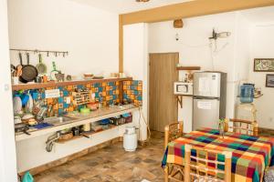 a kitchen with a table and a sink and a refrigerator at Casa Mazunte Tierra Viva in Mazunte +29 photos