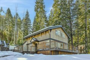 a log cabin in the woods in the snow at Granlibakken Getaway- West Shore Retreat-Central Location-Hot Tub-Near Skiing in Tahoe City