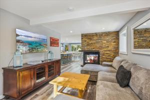 a living room with a couch and a fireplace at Granlibakken Getaway- West Shore Retreat-Central Location-Hot Tub-Near Skiing in Tahoe City