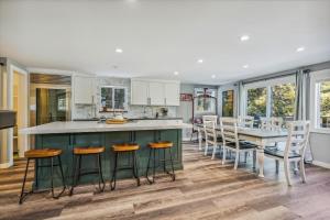 a kitchen with a green island and a table with chairs at Granlibakken Getaway- West Shore Retreat-Central Location-Hot Tub-Near Skiing in Tahoe City