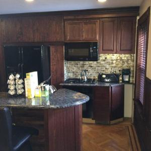 a kitchen with wooden cabinets and a counter top at Garden Apartment with Private Entry in Brooklyn