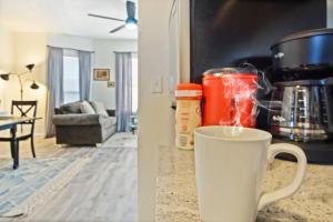 a cup of coffee on a counter in a living room at Elegant Comfort House -modern Amenities- 40-1 in Oklahoma City