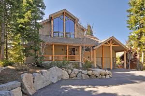 a house with a stone fence in front of it at Sierra Crest at Palisades Tahoe - Secluded Luxury 5BR 5 BA w Wood Fireplace in Olympic Valley