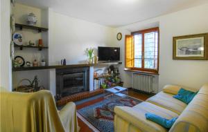 a living room with a couch and a fireplace at 5 Bedroom Nice Home In Castelvecchio Di Comp, in Castelvecchio