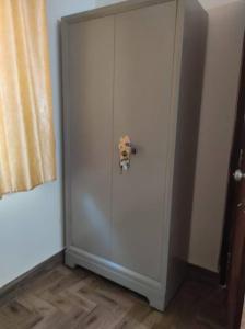 a white door with a dog on it in a room at Muktamma in Tiruvannāmalai