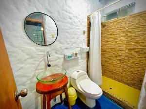 a bathroom with a sink and a toilet and a mirror at Huanchaco Domes in Huanchaco +29 photos