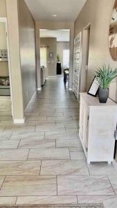 a hallway with a tile floor in a building at Paradise Oasis! Waterfall pool & spa in Lake Havasu City