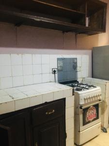a kitchen with a stove and a counter top at Arusha homestay in Arusha