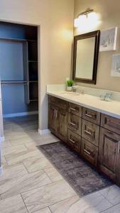 a bathroom with a sink and a mirror at Paradise Oasis! Waterfall pool & spa in Lake Havasu City