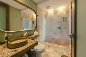 a bathroom with a sink and a toilet and a shower at The Brown, Guatape in Guatapé