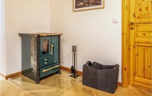 a room with a green grandfather clock and a chair at Ferienhaus Bergblick in Gschwend