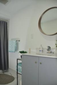 a bathroom with a sink and a mirror at Entire Basement - 5 Guests 2 Bedrooms 3 Beds in Toronto