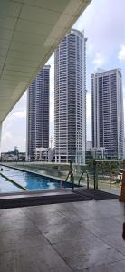 a swimming pool in a city with tall buildings at Modern and Comfortable Staycation - Unit 3718 Novotel Tower in Manila