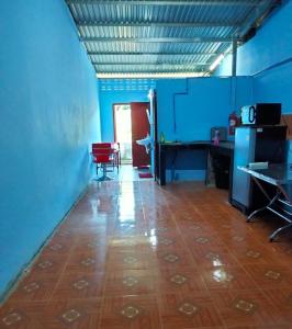 an empty room with blue walls and a wooden floor at Paksong Brand New- Two-story house in Muang Pakxong