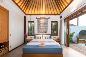 a bedroom with a bed with a towel on it at Suga Estate - Rice Field View Villas in Ubud
