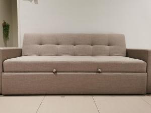 a brown couch sitting in a living room at 28 Residence Homestay in Melaka