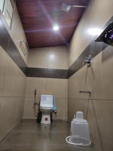 a bathroom with a toilet and a shower at Hang on in Anachal