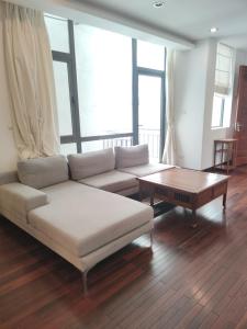 a living room with a couch and a coffee table at Davidduc's Duplex Apartment Xom Chua (5F) in Hanoi