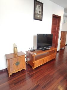 a living room with a flat screen tv on a entertainment center at Davidduc's Duplex Apartment Xom Chua (5F) in Hanoi