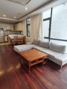 a living room with a white couch and a table at Davidduc's Duplex Apartment Xom Chua (5F) in Hanoi