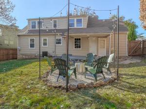 a patio with chairs and a table in front of a house at 4 Bedroom Plaza Charmer Pet Friendly in Kansas City