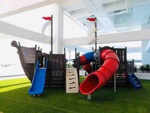 a playground with a red and blue slide at The Wave Residences Melaka Kota Laksamana in Melaka