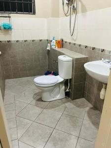 a bathroom with a toilet and a sink at Semi -D Homestay Seremban 2 in Seremban