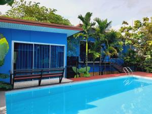 a blue house with a blue swimming pool at RadHut in Chalong +19 photos