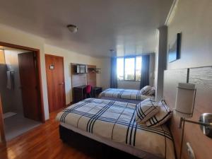 Postel nebo postele na pokoji v ubytování Hotel Rincon Aleman