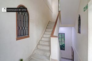 a staircase in a church with a stained glass window at Super Collection O Townvilla Guest House near Begumpet Metro Station in Hyderabad