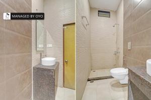 a bathroom with a toilet and a sink and a shower at Super Collection O Townvilla Guest House near Begumpet Metro Station in Hyderabad