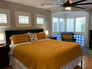 a bedroom with a bed and a ceiling fan at Coastal Sea Side Townhome in Clearwater Beach