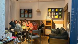 a group of people sitting at a table in a room at Wally House青山惠风民宿 in Zhangjiajie