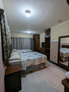 a bedroom with a bed and a mirror at Casa González in Santiago Atitlán