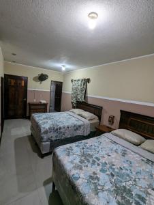a hotel room with two beds and a room with two beds at Casa González in Santiago Atitlán
