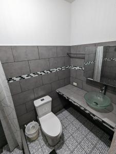 a bathroom with a toilet and a sink at Casa González in Santiago Atitlán