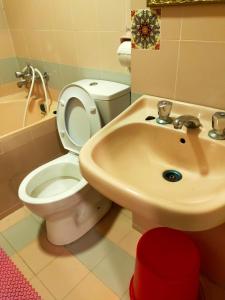 a bathroom with a toilet and a sink at R2L5Y Room 1 with balcony and bathroom in Bentong