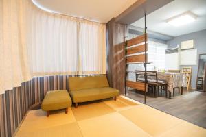 a living room with a chair and a table at Yiyihouse shinsaibashi in Osaka