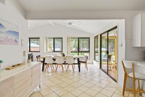 a kitchen and dining room with a table and chairs at Waterfront Pet-Friendly Abode - Toukley NSW in Toukley