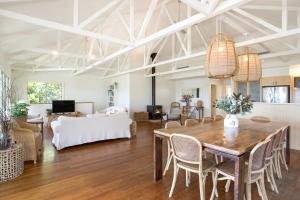 a living room with a table and chairs at The Treehouse Vincentia in Vincentia